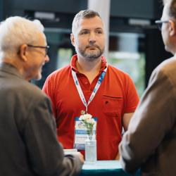 People standing around a table, talking