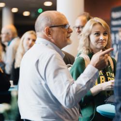 People standing around a table, talking