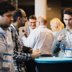 People standing around a table, talking
