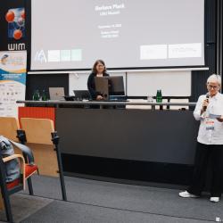 Person giving to a presentation in an auditorium