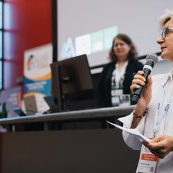 Person giving to a presentation in an auditorium