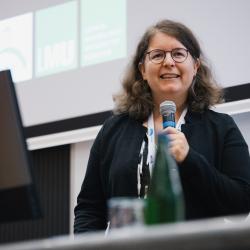 Person giving to a presentation in an auditorium
