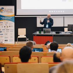 Person giving a presentation in a lecture room