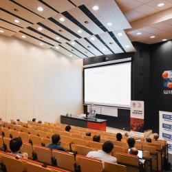 Lecture room with people listening to a presentation