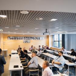 Lecture room with people listening to a presentation
