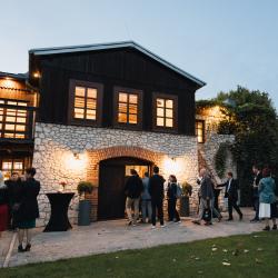 House in nature with people in front