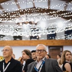 People in a banquet hall, drinking champagne