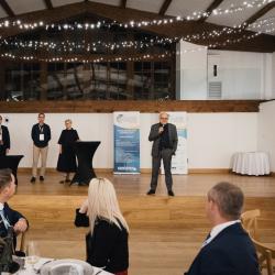 People on talking on stage in a banquet hall