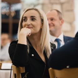 People listening and sitting at a table