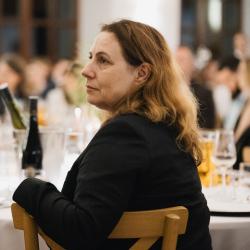 People listening and sitting at a table