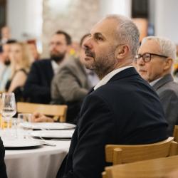 People listening and sitting at a table