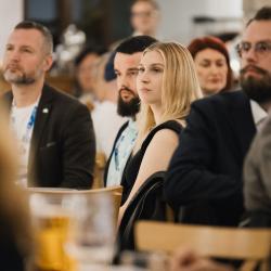 People listening and sitting at a table