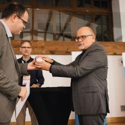 A person giving a gift to another person