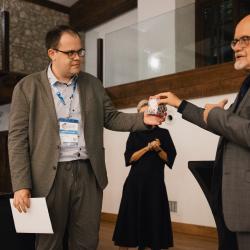 A person giving a gift to another person