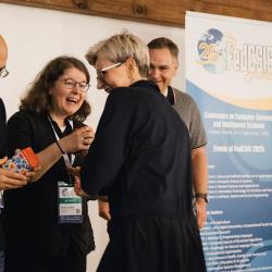 People giving and receiving gifts in a banquet hall