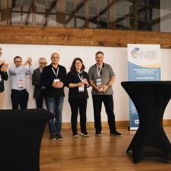 People celebrating on stage in a banquet hall
