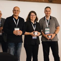 People giving and receiving gifts in a banquet hall