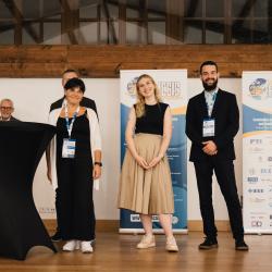 People celebrating on stage in a banquet hall