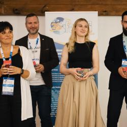 People celebrating on stage in a banquet hall