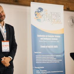 Person standing next to a poster