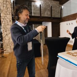People next to a big birthday cake