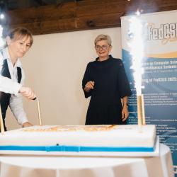 Firework candles burning on a big birthday cake