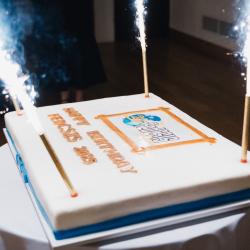 Firework candles burning on a big birthday cake