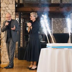 Firework candles burning on a big birthday cake