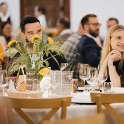 People sitting at the tables in a banquet hall